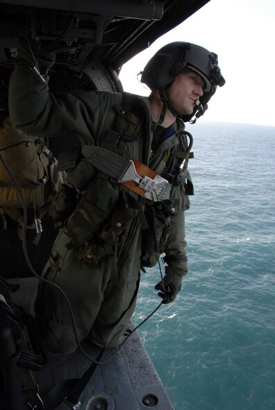 Staff Sgt. Joseph Kenney observes the surrounding area for flight safety during a flight to the Farallon Islands Feb. 17.  The unit is supporting the U.S. Fish and Wildlife Service by transporting new photovoltaic batteries to power a lighthouse and workshop at the FWS research facility on the Farallon Island, which sits some 30 miles west of San Francisco.  Sergeant Kenney is an HH-60G Pave Hawk helicopter flight engineer from the California Air National Guard's 129th Rescue Wing at Moffett Federal Airfield, Calif.  (U.S. Air Force photo/Tech. Sgt. Ray Aquino)