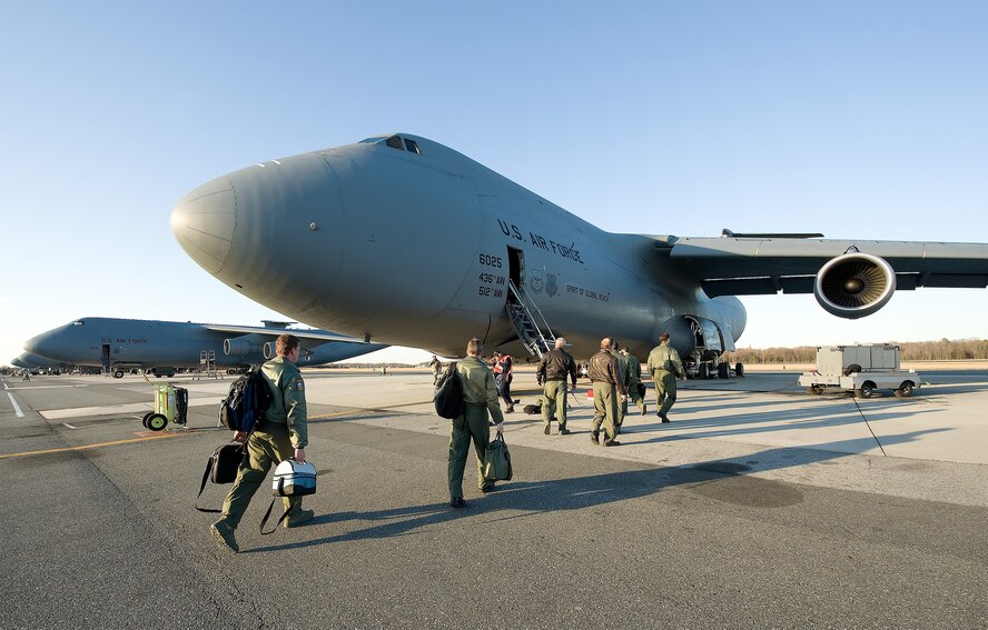 A 709th Airlift Squadron aircrew here boards The Spirit of Global Reach for their first local training mission Feb. 17. The aircraft arrived at Dover Air Force Base, Del., Feb. 9 and is the first of three C-5M Super Galaxies the base will receive for operational testing and evaluation. The 709th AS is a unit in the Air Force Reserve's 512th Airlift Wing. (Air Force photo/Jason Minto)