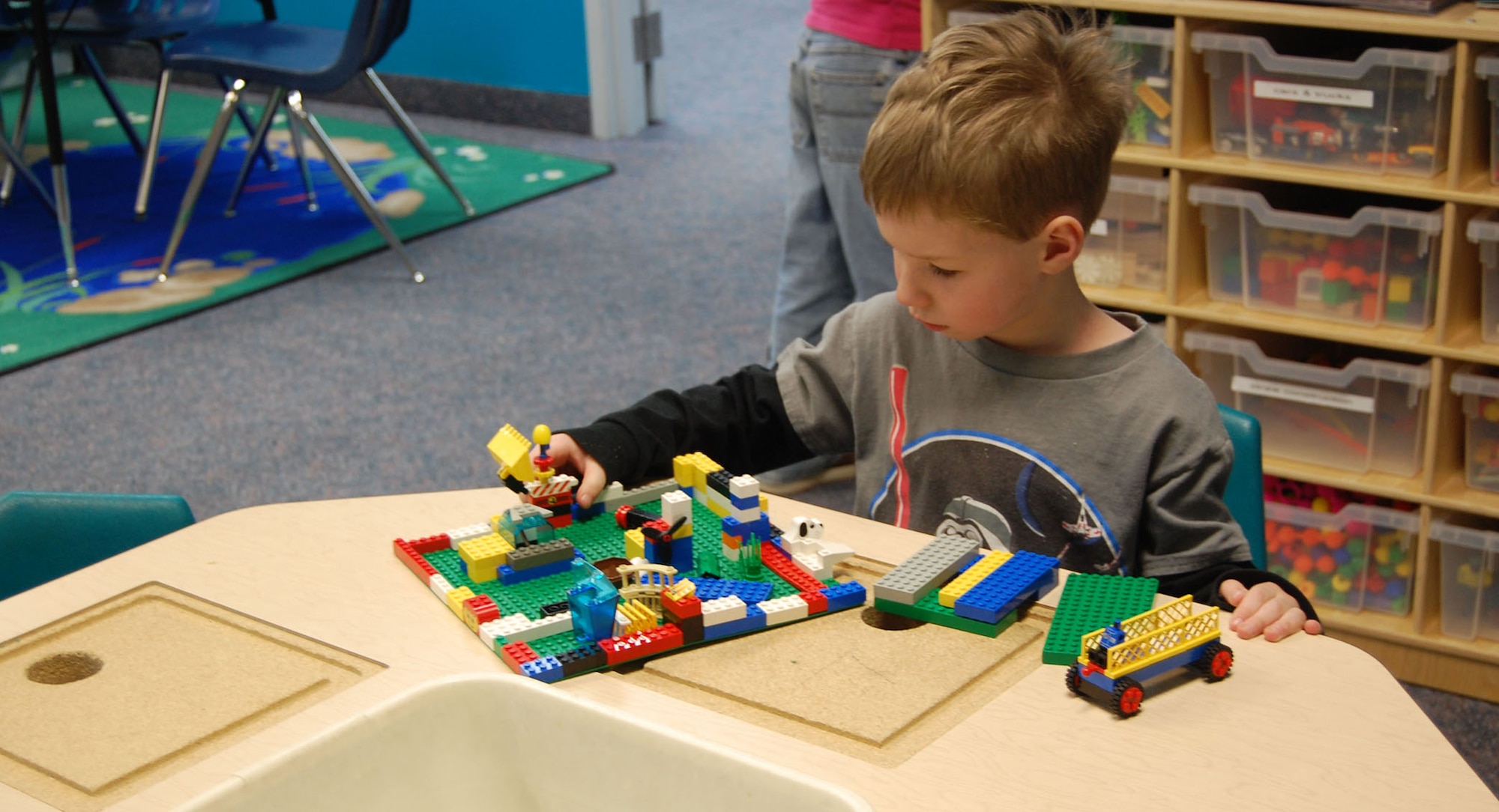Little Warrior Riley, 6, plays with Legos at the Youth Center Feb. 5. He is one of several children enrolled in the before and after school program there. (U.S. Air Force photo/Valerie Mullett)