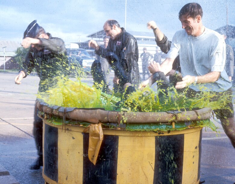 Capt. Richard Hammaker, an RF-4C backseater in the 14th TRS, being thrown into a vat of stagnant water, shark repellent, and anti-freeze kept just for end of tour dunkings. (U.S. Air Force photo)