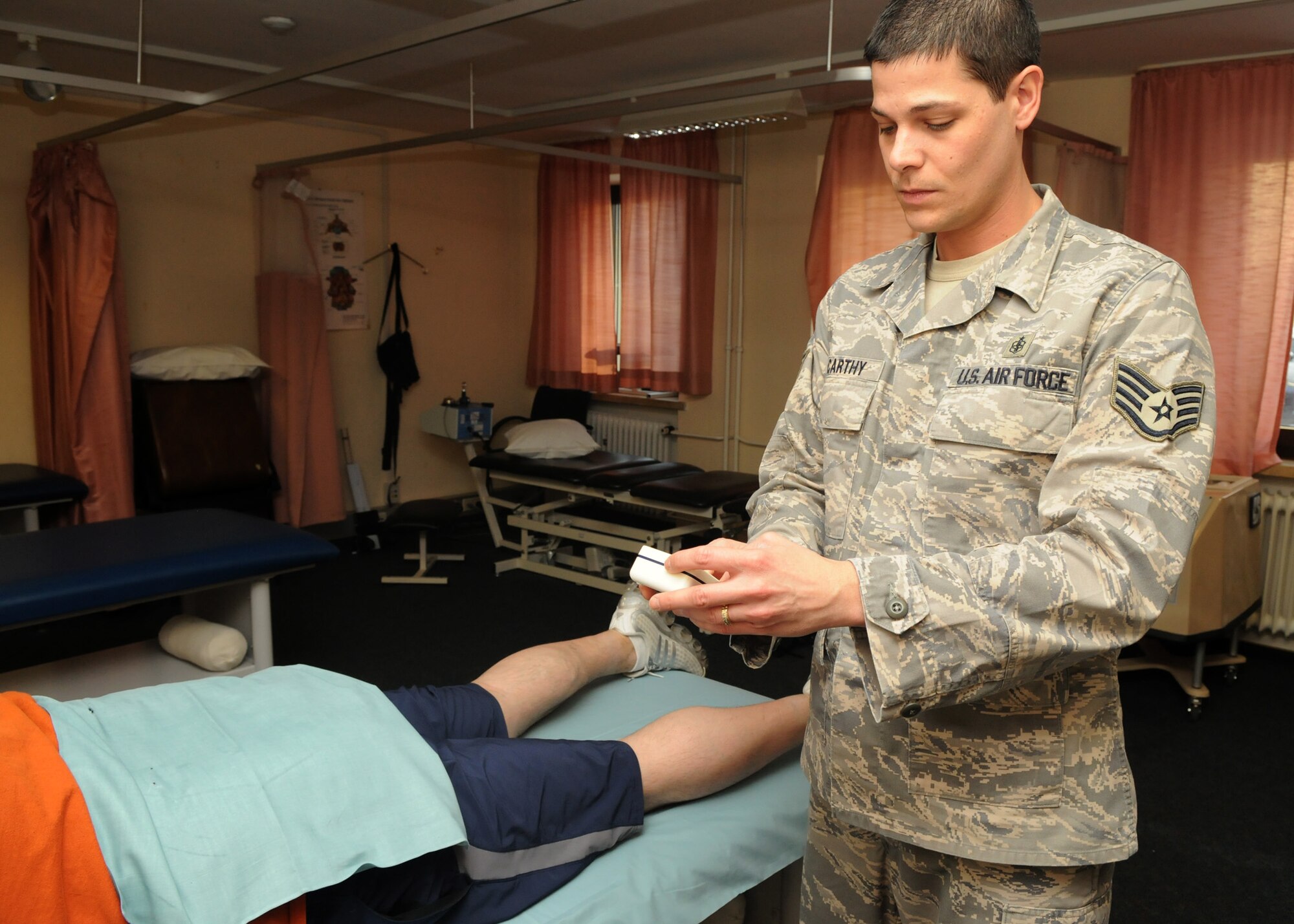 SPANGDAHLEM AIR BASE, Germany – Senior Airman Jaime Turner, 52nd Medical Operations Squadron, demonstrates a physical therapy exercise to Staff Sgt. Matthew Bright, 52nd Fighter Wing, Feb. 12, 2009. Physical therapy is often suggested for injuries and movement problems from an illness, disease or disability. (U.S. Air Force photo by Airman 1st Class Staci Miller)