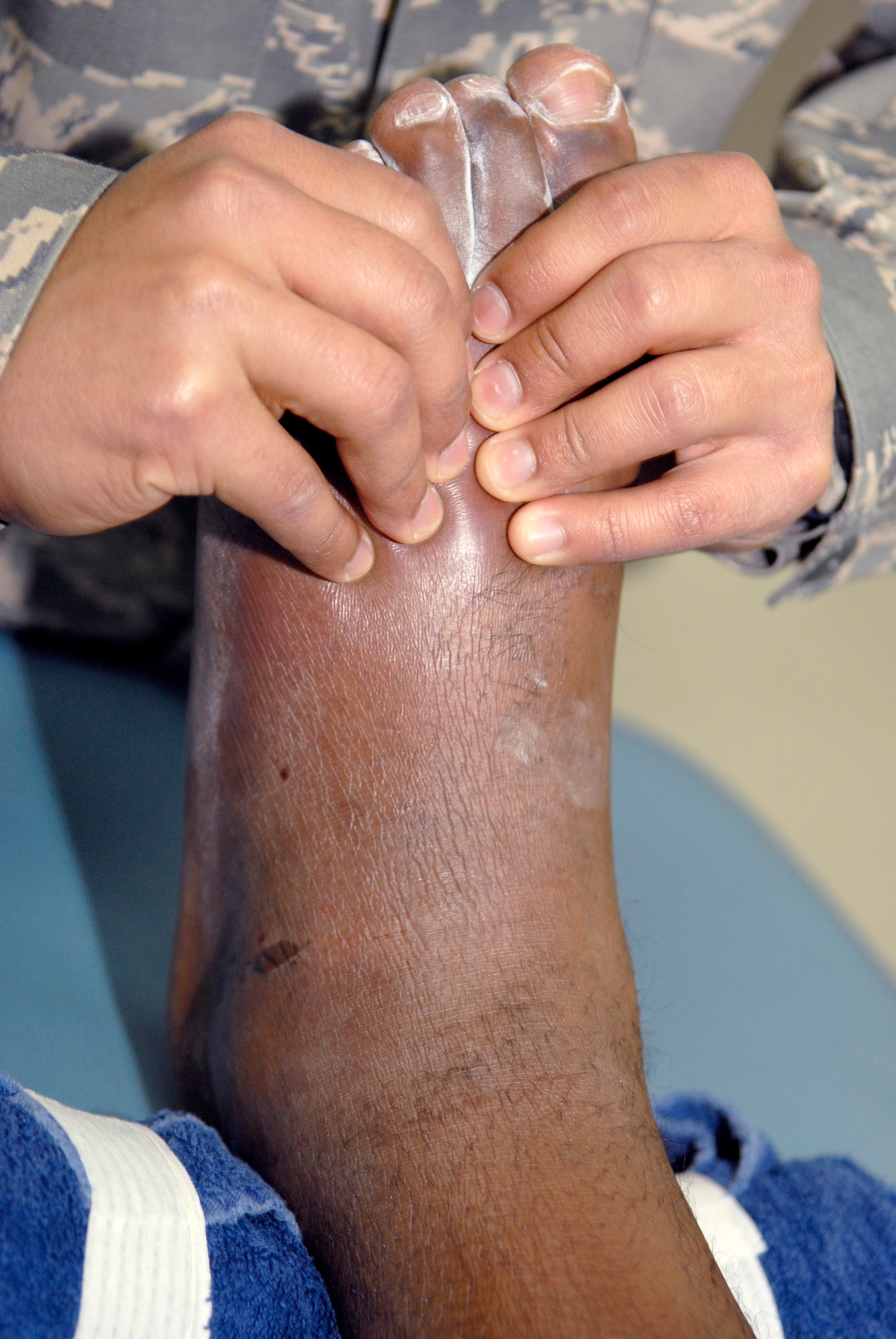 Staff Sergeant David Garcia, the 379th Expeditionary Medical Group Noncommissioned Officer in Charge of Physical Therapy, performs isometric muscle strengthening on a patient for a high ankle sprain to help decrease the swelling and increase his range of motion, Feb. 19, 2009, at an undisclosed location in Southwest Asia.  Staff Sergeant Garcia hails from Fredericksburg, Texas and is deployed from Andrews Air Force Base, Md. in support of Operations Iraqi and Enduring Freedom and Combined Joint Task Force - Horn of Africa.   (U.S. Air Force Photo by Airman 1st Class Andrew Satran/Released)