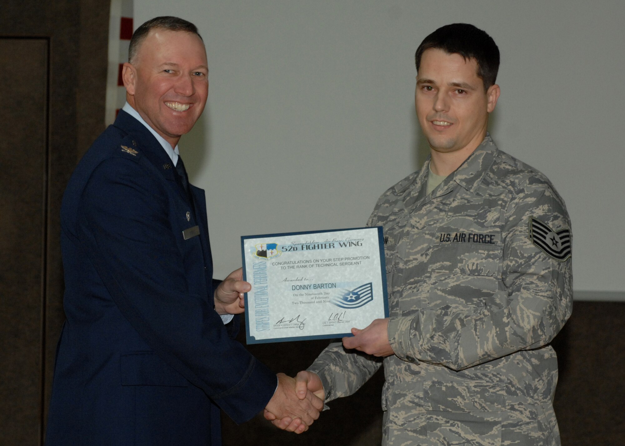 SPANGDAHLEM AIR BASE, Germany -- Tech. Sgt.Donny Barton, 470th Air Base Squadron, is congratulated by Col. Lee Wight, 52nd Fighter Wing commander, for achieving a Stripes for Exceptional Performers Promotion to technical sergeant Feb. 19, 2009. Each year a limited number of Airmen receive a STEP promotion for continually doing outstanding work. (U.S. Air Force photo by Senior Airman Jenifer H. Calhoun)