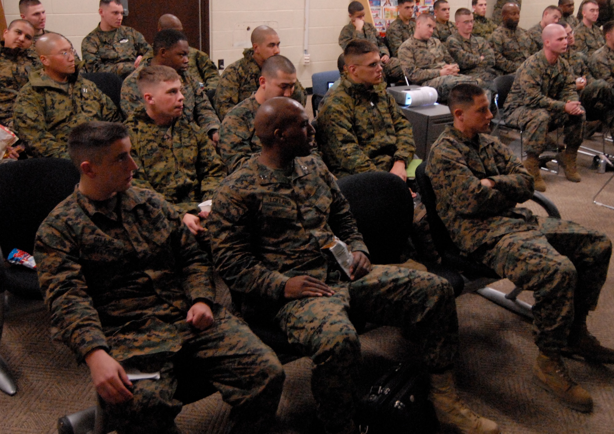 Marines from the 1st Marine Aircraft Wing, out of Okinawa, Japan, listen during their in-processing briefing at Kunsan Air Base, Republic of Korea, Feb. 20, 2009. Kunsan Airmen got to practice accepting follow-on forces ahead of the local operational readiness exercise as they received the first group of more than 400 Marines coming to Kunsan to participate in Exercise Key Resolve. Key Resolve is a routine training exercise designed to provide training for U.S. forces in the various aspects of reception, staging, onward movement, and integration as well as focusing on rear area security and sustainment operations. (U.S. Air Force Photo/Senior Airman Gustavo Gonzalez)