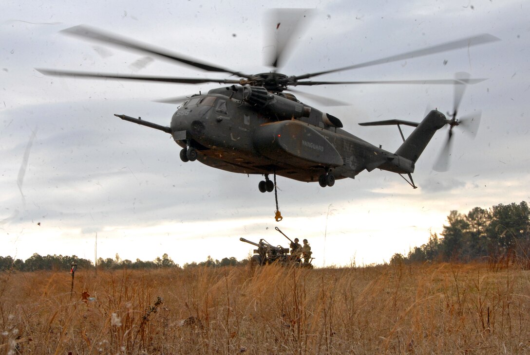 A U.S. Navy MH-53E Sea Dragon helicopter prepares to sling load a C3 ...