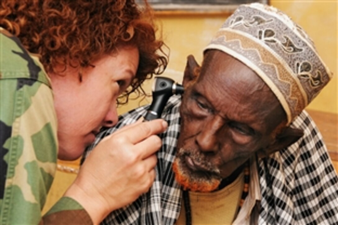 U.S. Air Force Maj. Traci Morris checks the ears of a village elder during a Medical Civil Action Program visit to Milo, Ethiopia, Feb. 10, 2009. The program enables military people to offer medical assistance and services to village members who would otherwise go without help.