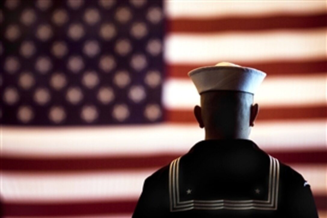 A U.S. sailor assigned to the Ohio-class ballistic missile submarine USS Rhode Island stands at attention while top military leaders board the submarine during a ceremony marking the 1000th Trident submarine patrol in Kings Bay, Ga.