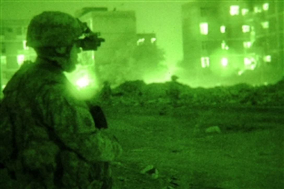 As seen through a night-viewing device, U.S. paratroopers patrol with Iraqi police officers in the Rusafa district of eastern Baghdad, Iraq, Feb. 16, 2009. The paratroopers, assigned to the 82nd Airborne Division's 73rd Cavalry Regiment, 3rd Brigade Combat Team, partnered with Iraqi police to check for improvised explosive devices or signs of insurgent activity.