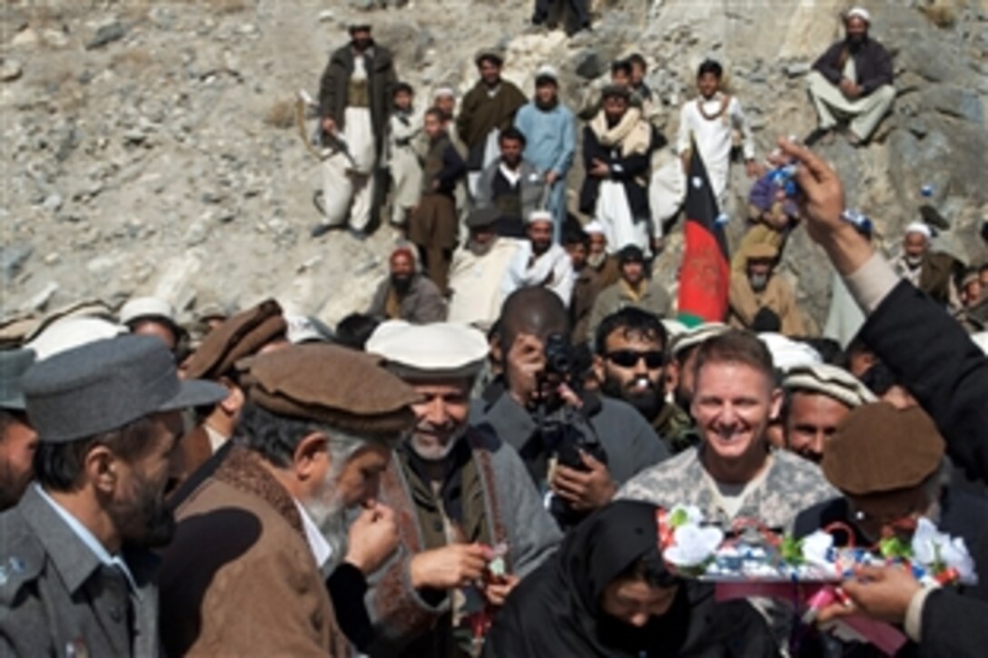 Konar Provincial Reconstruction Team members and Konar officials cut a ribbon to officially open the Guryak Truck Bridge in Konar province, Afghanistan, Feb. 17, 2009. Team members and Afghan crews worked for a year to complete the $1.7 million bridge.