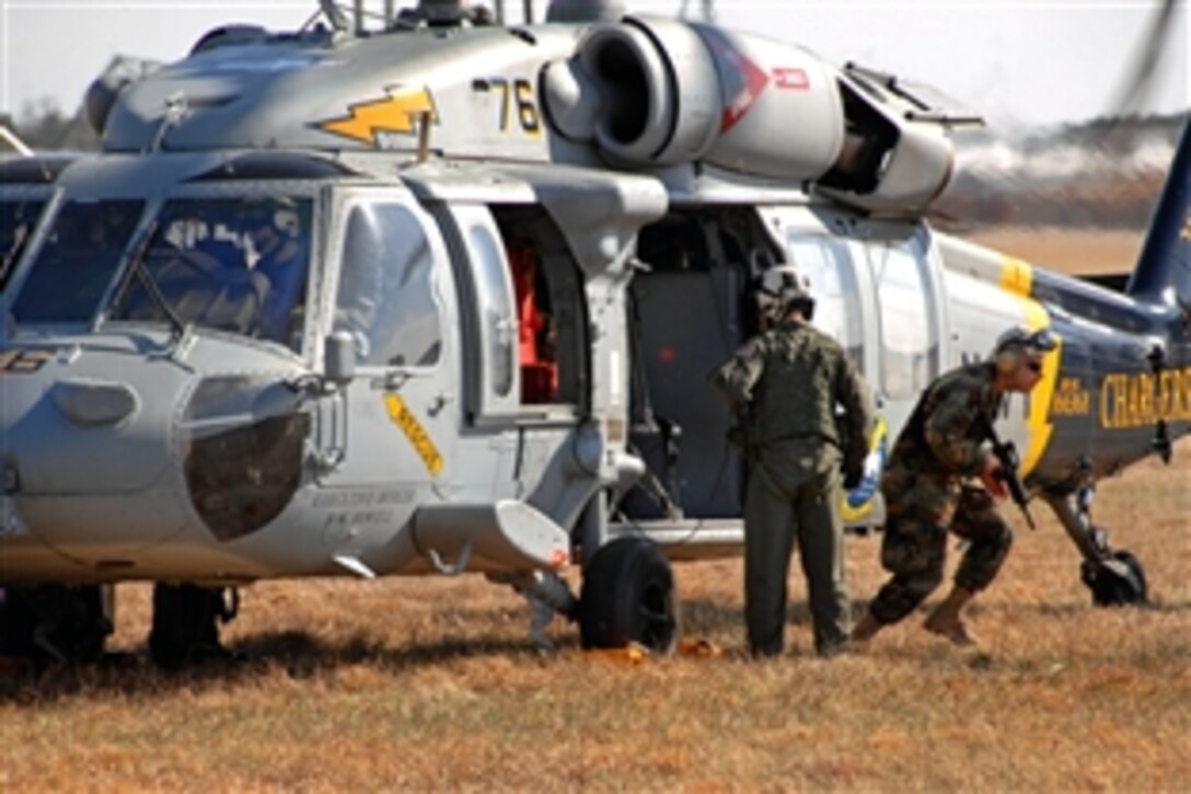 A Canadian army soldier exits a U.S. Navy MH-60 Sea Hawk helicopter during Exercise Southbound Trooper IX on Blackstone Army Airfield, Fort Pickett Va., Feb. 14, 2009.