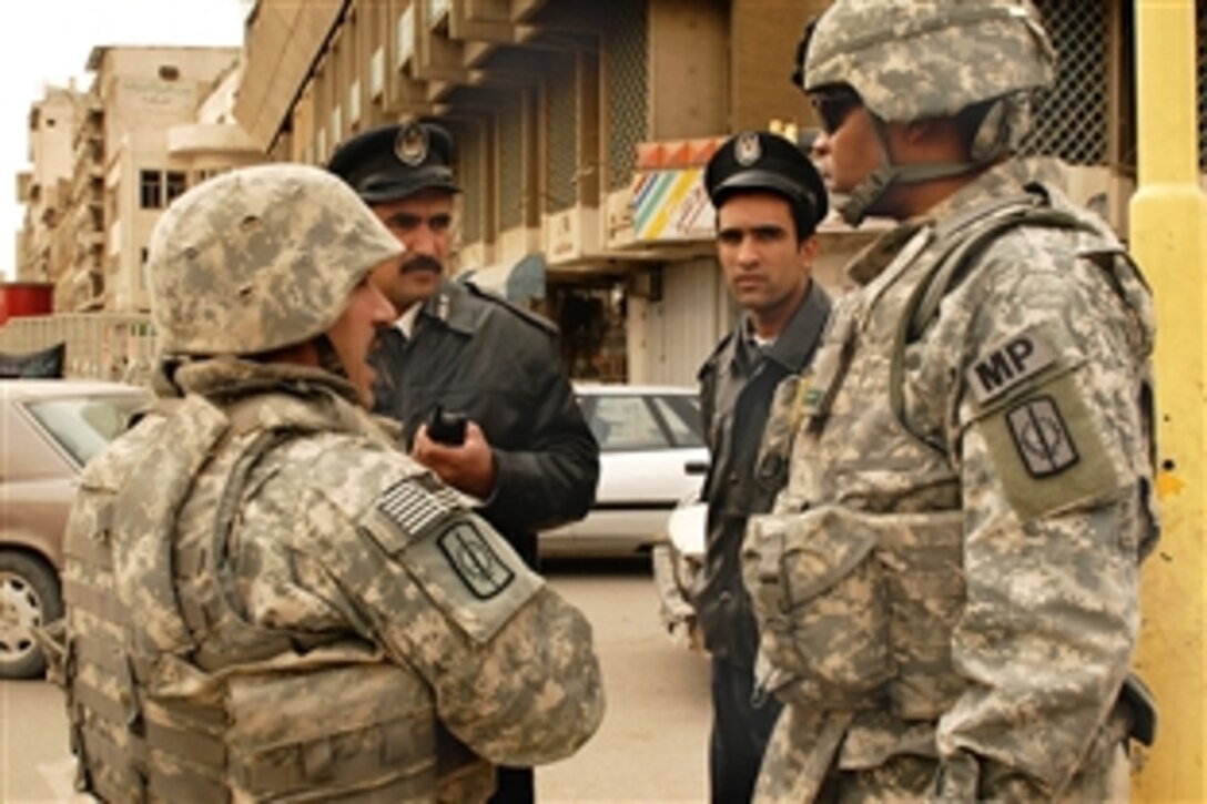 U.S. Army Col. Byron Freeman visits a checkpoint, Feb. 14, 2009, during heightened security implementations at checkpoints throughout Baghdad, Iraq, to prepare for Arba'een, a religious holiday pilgrimage. Freeman commands the 8th Military Police "Watchdog" Brigade.
