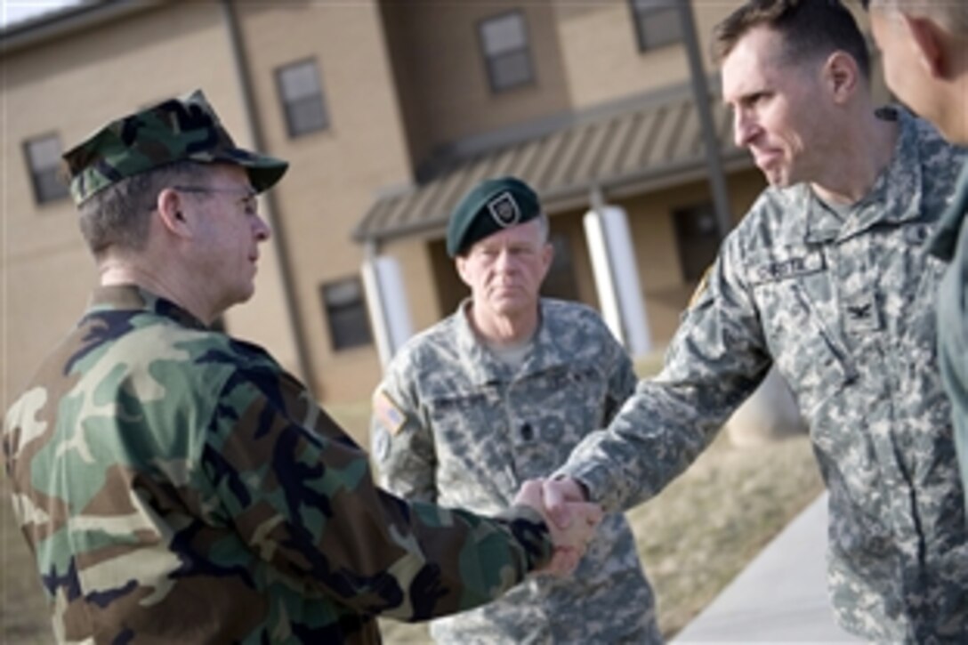 Navy Adm. Mike Mullen, left, chairman of the Joint Chiefs of Staff, bids farewell to Army Col. Duke Christie, deputy commander of the 5th Special Forces Group, and Command Sgt. Maj. Michael A. Cunningham after visiting with soldiers on Fort Campbell, Ky., Feb. 20, 2009. Mullen is wrapping up visits to stateside bases, where he visited troops serving there.
