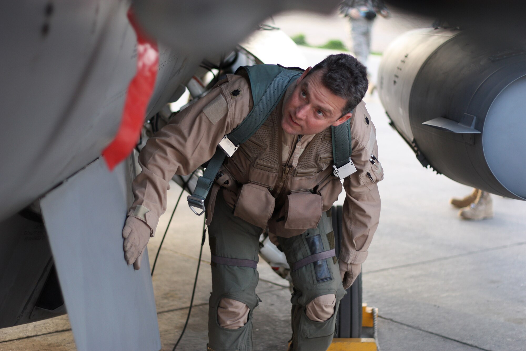 JOINT BASE BALAD, Iraq -- Lt. Col. David Smith, 332nd Expeditionary Fighter Squadron commander, visually checks his F-16 Fighting Falcon here Feb. 8 before taking off with a silk map that last flew in World War II during a bombing mission over Germany. Smith is deployed from Homestead Air Reserve Base, Fla., and his hometown is Miami. (U.S. Air Force photo/Tech. Sgt. Lionel Castellano)