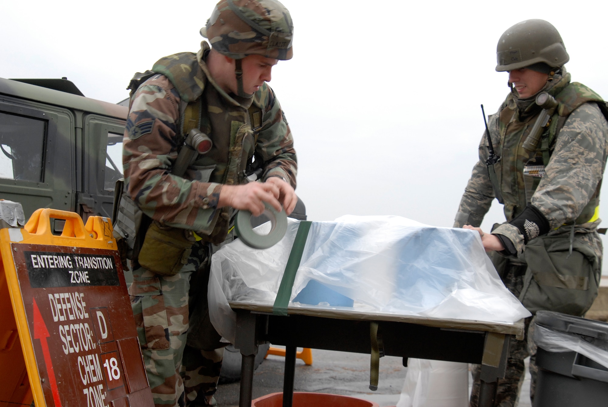 Senior Airman Christopher Clazie and Staff Sgt. Keith Cole, working with the 8th Security Forces Squadron, set up a zone transition point during a local operational readiness exercise at Kunsan Air Base, Republic of Korea, Feb. 22, 2009. The local exercise, Beverly Midnight 09-01, is testing the wing's ability to effectively operate in simulated wartime contingencies. (U.S. Air Force Photo by SSgt Jason Colbert)
