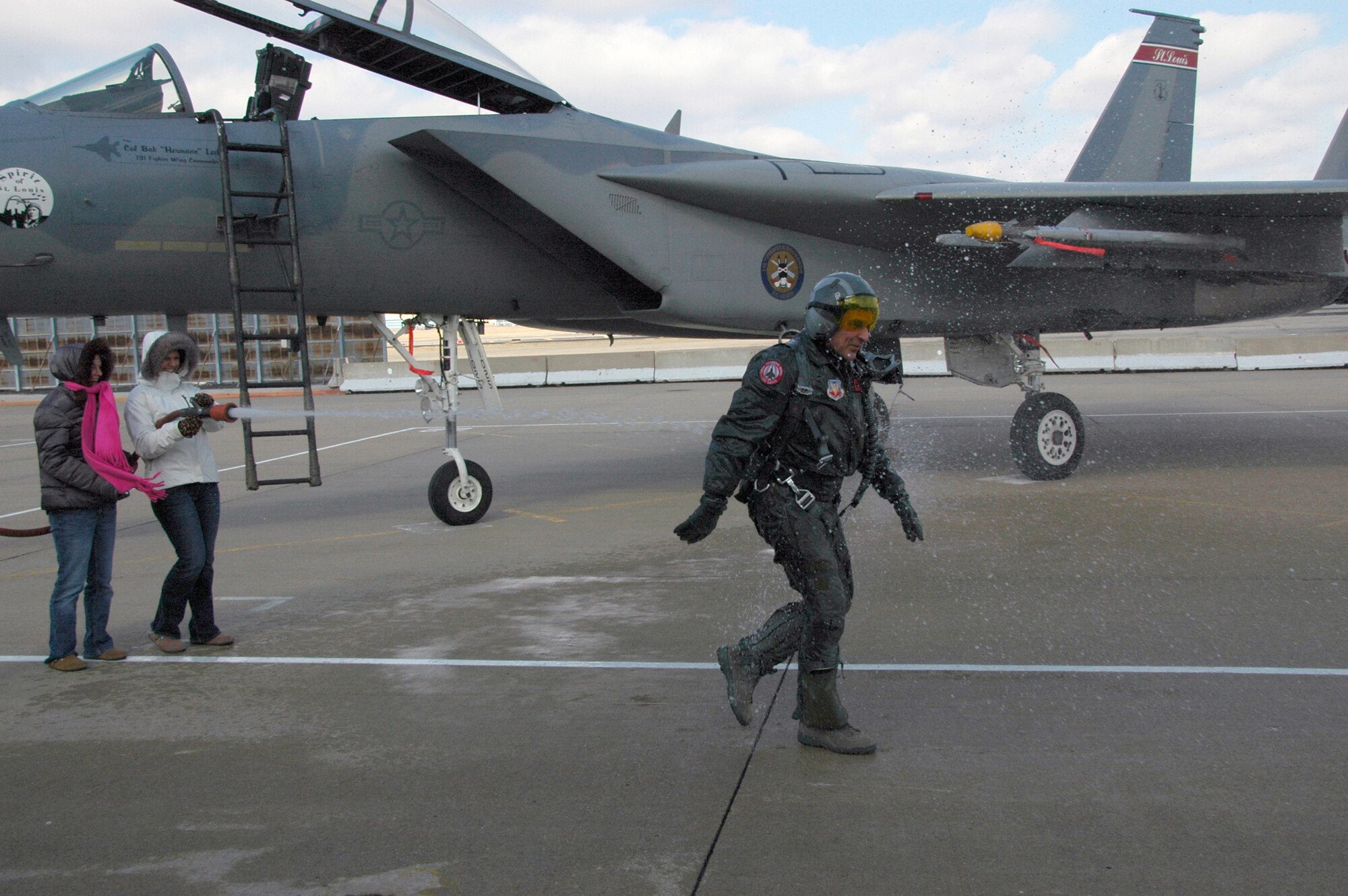 Col. Robert Leeker, 131st Wing Commander gets hosed down by his daughters after his final F-15 flight from Lambert International Airport, Feb. 21, 2009. (Photo by MSgt. Mary-Dale Amison)