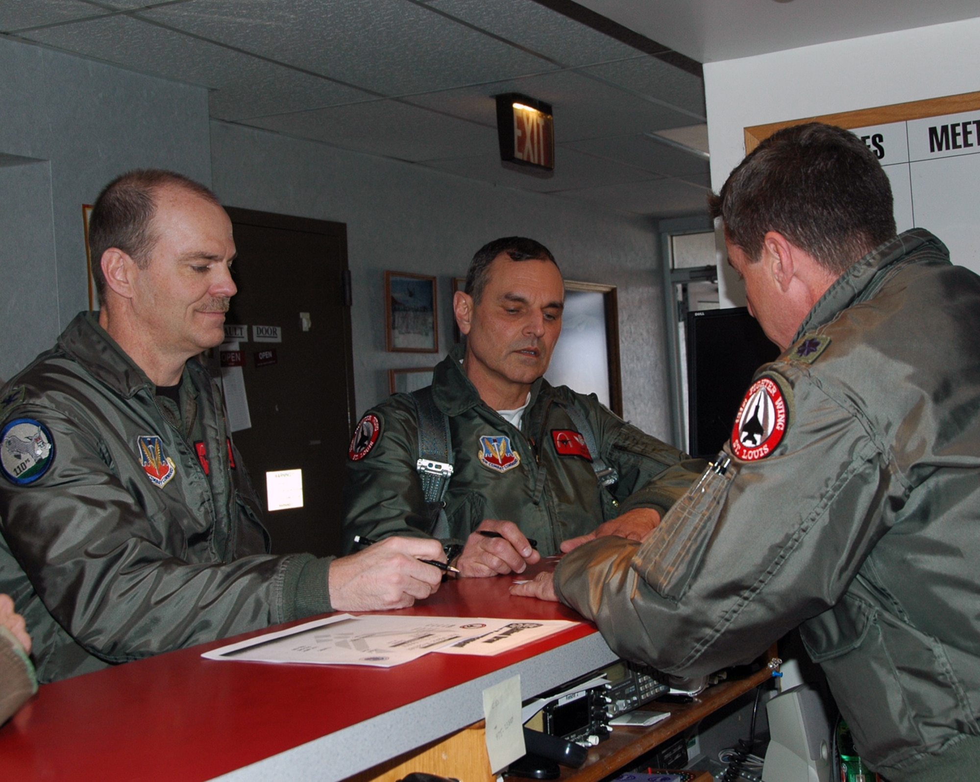 Col. Robert "Herm" Leeker, 131st Wing Commander and Col. Robert "Mos" Mohr receive pre-flight instructions from Lt. Col. Mike "Father" Flanagan prior to Leeker's final F-15 flight on Feb. 21 at Lambert International Airport. (Photo by MSgt. Mary-Dale Amison)