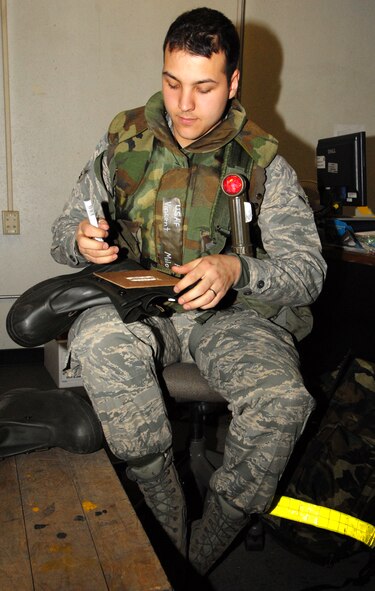 Airman Vincent Milone, 8th Logistics Readiness Squadron, labels a pair of protective gloves for training use only during Operational Readiness Exercise Beverly Midnight 09-01 at Kunsan Air Base, Republic of Korea, Feb. 23, 2009. (U.S. Air Force Photo/Senior Airman Gustavo Gonzalez)