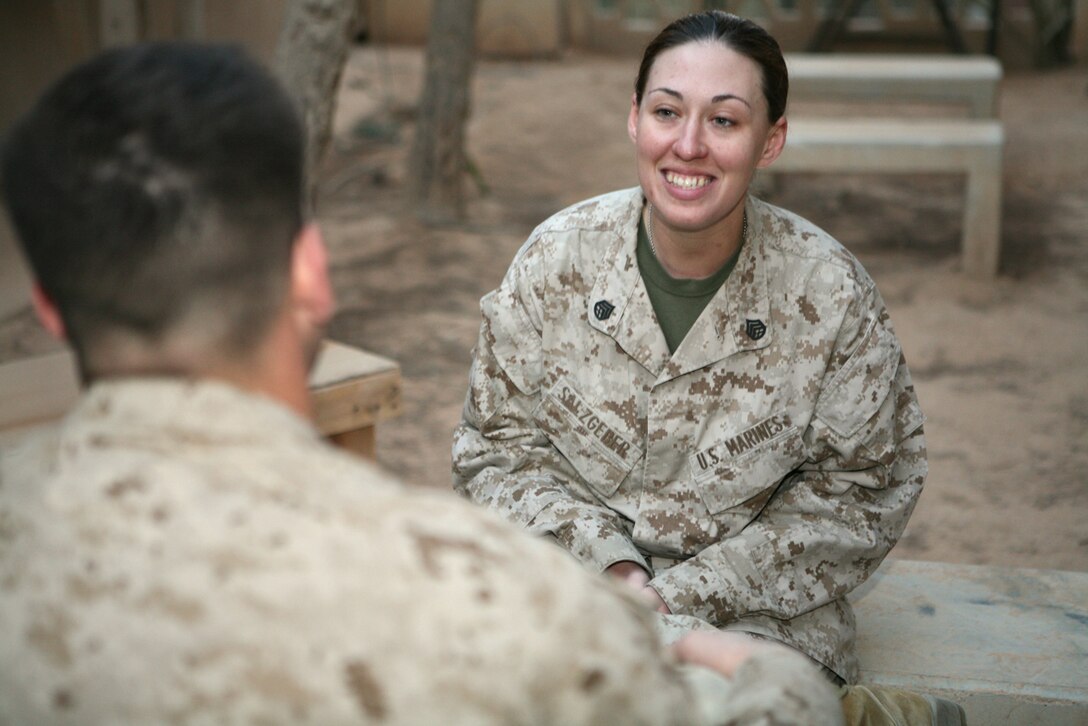 Staff Sgt. Tracy Salzgeber, a 2007 University of Maryland graduate and Arabic interpreter with Civil Affairs Group, Regimental Combat Team 8, converses in Arabic with Seaman Tyler Ivy. Salzgeber feels learning about Iraqi language and culture is important because, "They have an easier time seeing us as fellow human beings when you break through the language barrier."
