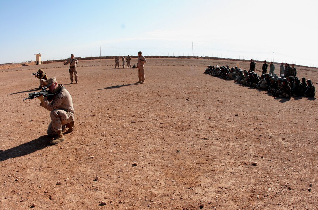 Reserve Marines from Company E, 2nd Battalion, 25th Marine Regiment, Regimental Combat Team-8, demonstrate infantry fire and movement techniques to soldiers from the 3rd Battalion, 29th Brigade, 7th Iraqi Army Division at H3 Airfield Feb. 23, 2009.  Company E is finishing up a 7-month tour in Iraq and is scheduled to return to their home training center in Harrisburg, Pa. in April.