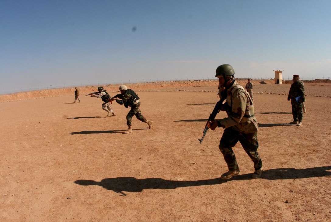 A squad of Iraqi Army soldiers from 3rd Battalion, 29th Brigade, 7th Iraqi Army Division rush a notional enemy during an exercise at H3 Airfield in a remote location in western Al Anbar Province Feb. 23.  During the last mission of their 7-month tour in Iraq, the Reserve Marines of Company E, 2nd Battalion, 25th Marine Regiment, Regimental Combat Team-8 taught fire and movement techniques to their Iraqi counterparts.