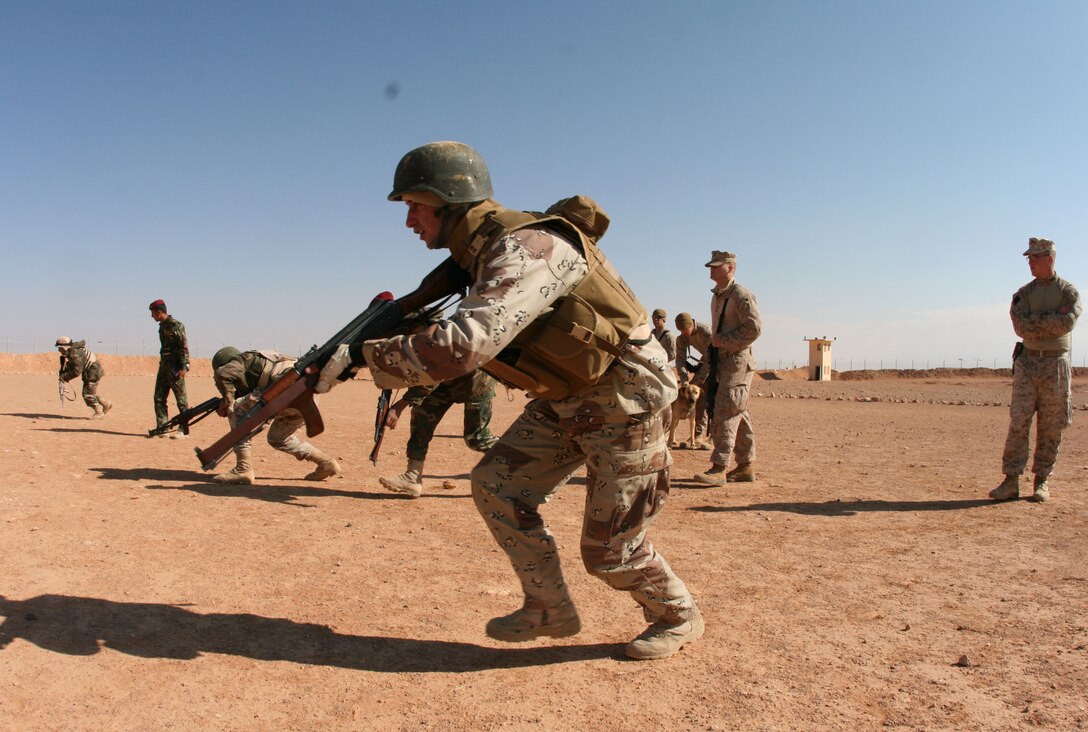 Under the tutelage of Reserve Marines from Company E, 2nd Battalion, 25th Marine Regiment, Regimental Combat Team-8, a squad of Iraqi Army soldiers from 3rd Battalion, 29th Brigade, 7th Iraqi Army Division perform fire and movement techniques at H3 Airfield in a remote location in western Al Anbar desert Feb. 23.