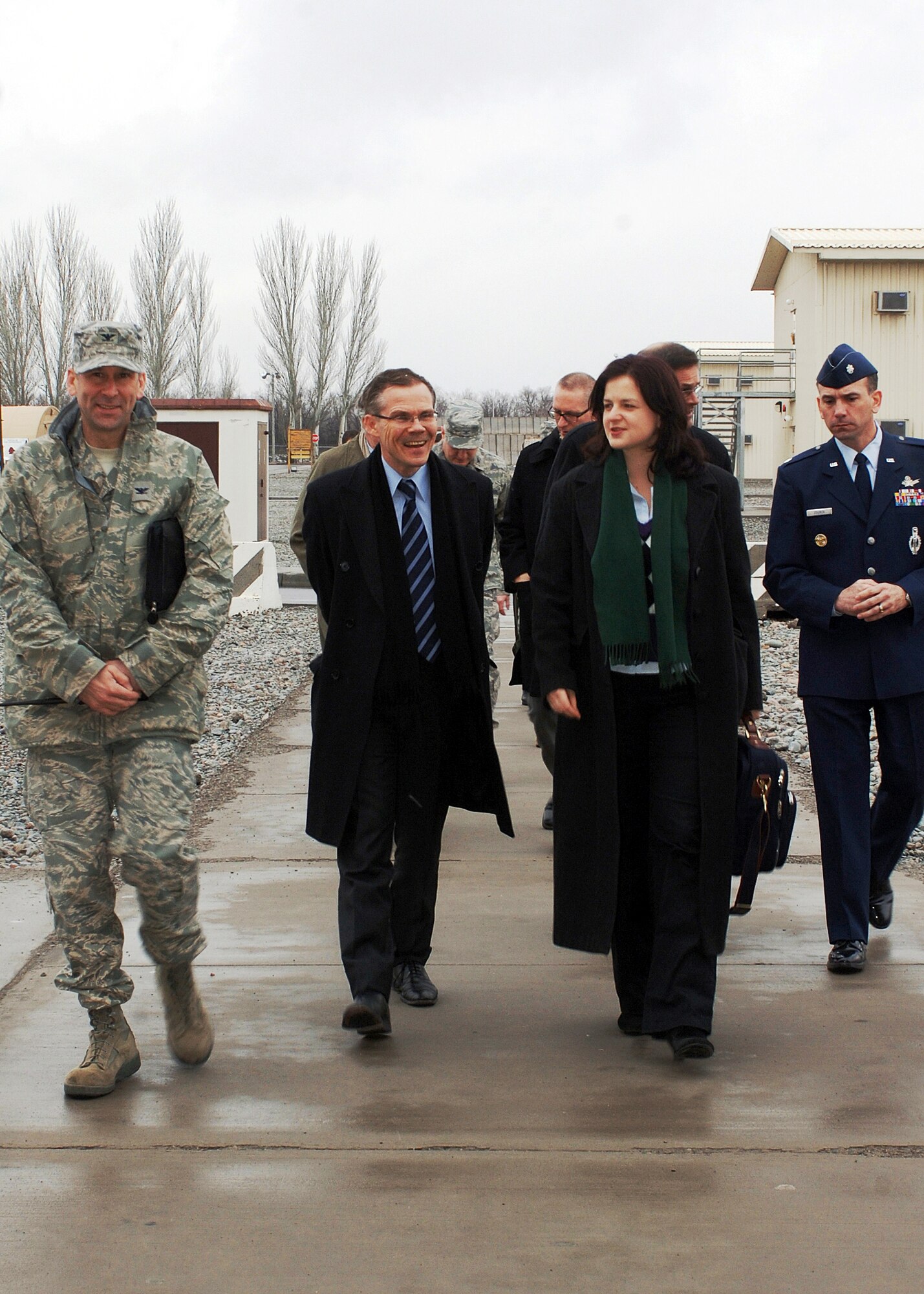 Col. Christopher Bence, 376th Air Expeditionary Wing commander (l), and Lt. Col. Jeff Zoubek, Defense Attach? at the U.S. Embassy in Bishkek (r), escort a delegation of representatives from the European Union on a tour of Manas Air Base, Kyrgyzstan, Feb. 21. The five-person delegation, led by Ambassador Pierre Morel, received a tour of the air mobility hub and a wing mission brief during their visit. Coalition personnel from 25 EU countries transit through Manas in support of the International Security Assistance Force in Afghanistan.(U.S. Air Force photo/Tech. Sgt. Elizabeth Weinberg)