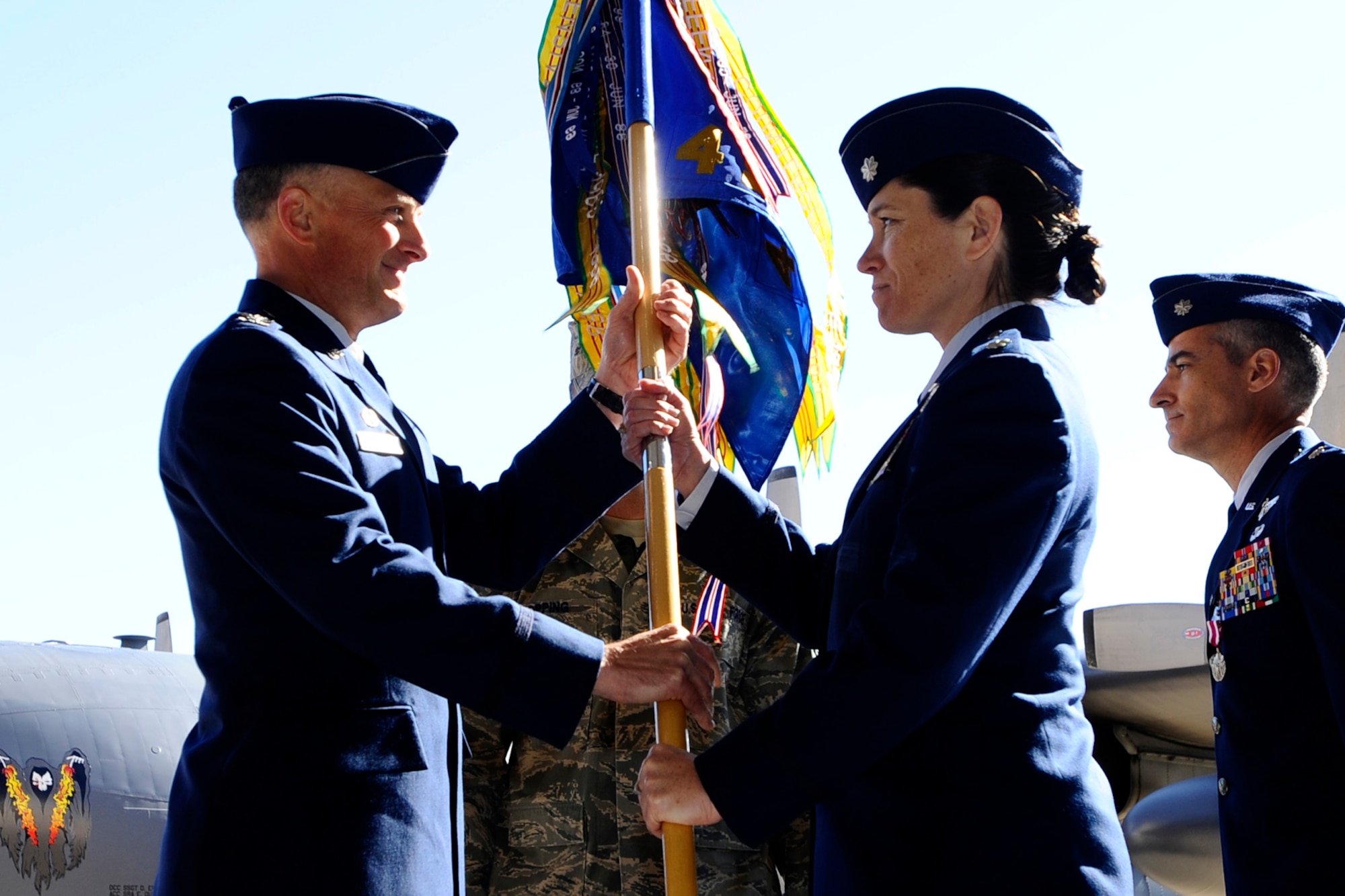 Lt. Col. Brenda Cartier, 4th Special Operations Squadron commander, is given the guidon to her new squadron by Col. Dennis Pannell, 1st Special Operations Group commander, during an change of commander ceremony here, Feb. 20. Colonel Cartier, the first female commander of a flying squadron, assumed command of the squadron from Lt. Col. Jim Rodriguez.