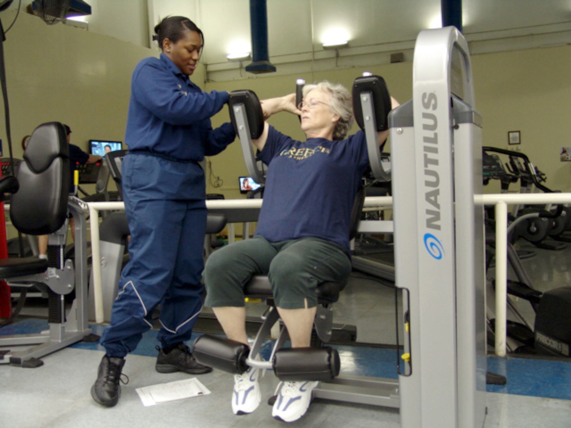Staff Sgt. Tonya Allen, fitness specialist, shows Trish Moye how to work on nautilus equipment at the Health and Wellness Center.  The HAWC has equipment, classes and programs for civil service civilians, retirees and family members in addition to active duty. (U.S. Air Force photo/Noel Getlin)