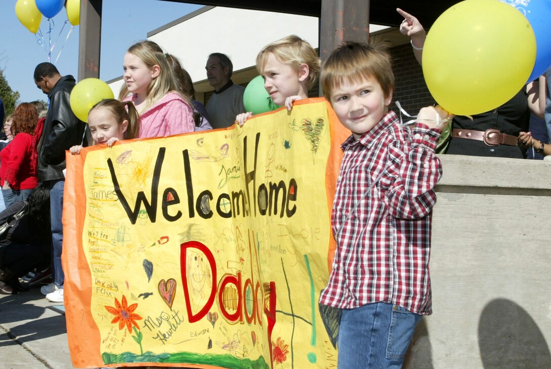 Dobbins Air Reserve Base, Ga. - Family members of a 94th Security Forces Squadron Airman returning from Iraq display a welcome home banner for "Daddy" while waiting with other families to meet and greet their loved ones from a six-month deployment.  Approximately 26 Airmen of the 94th Security Forces Squadron were deployed to Iraq in support of Operation Iraqi Freedom.  (U.S. Air Force photo/Don Peek)