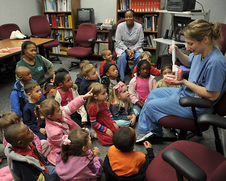MOODY AIR FORCE BASE, Ga. -- Staff Sergeant Ashley Morczko, 23rd Aeromedical-Dental Squadron dental technician, demonstrates oral hygiene to children from the Child Development Center here Feb 19. Children from the CDC toured the dental facility and were able to see equipment as part of Preventive Dental Health month. (U.S Air Force photo by Senior Airman Javier Cruz Jr.)