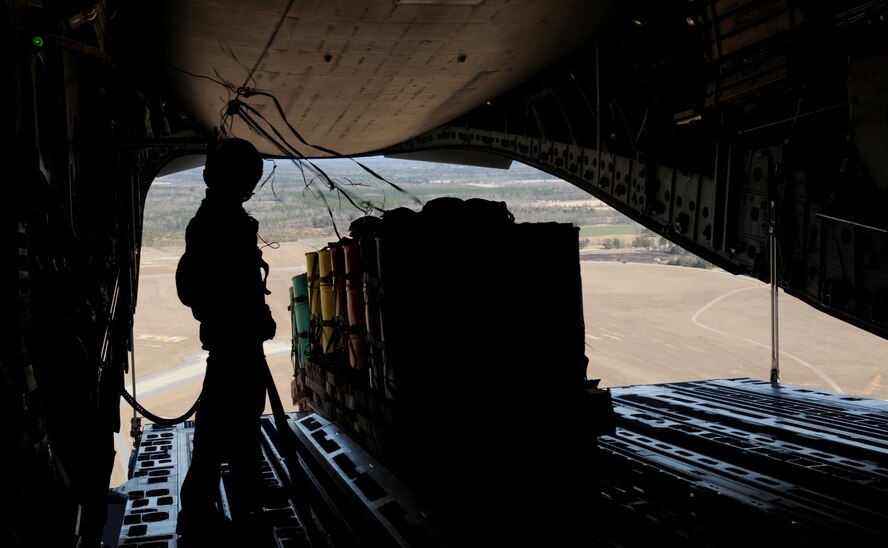 MOODY AIR FORCE BASE, Ga. -- A 820th Security Forces Group load master watches as a container filled with simulated cargo is air dropped out of a C-17 Globemaster III here Feb. 5. (U.S. Air Force photo by Senior Airman Gina Chiaverotti)
