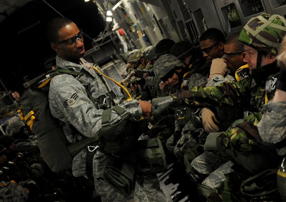 MOODY AIR FORCE BASE, Ga. -- Senior Airman Devant Davis-Jones, 820th Security Forces Group, motivates jumpers before a static line parachute jump out of a C-17 Globemaster III here Feb. 5. The 820th SFG was performing a joint jump with members of the II Squadron Royal Air Force Regiment from RAF Honington in Suffolk, Great Britain. (U.S. Air Force photo by Senior Airman Gina Chiaverotti)
