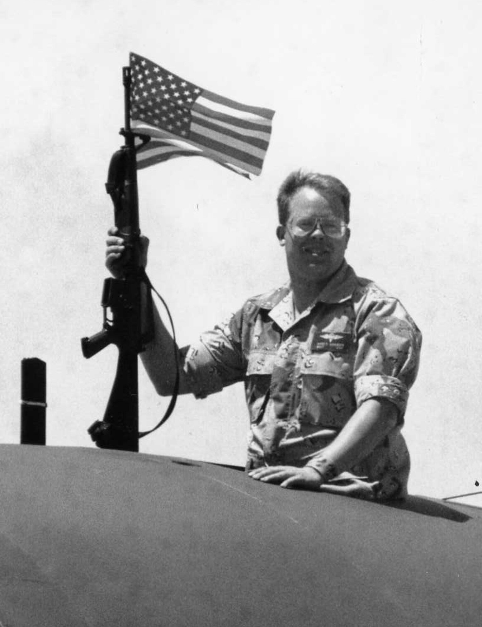 Proudly displaying 'Old Glory,' then-Master Sgt. Kirby Schueler returns from a deployment to the Middle East in May of 1991. Sergeant Schueler was deployed with the then-39th Mobile Aerial Port Squadron. (Courtesy photo)