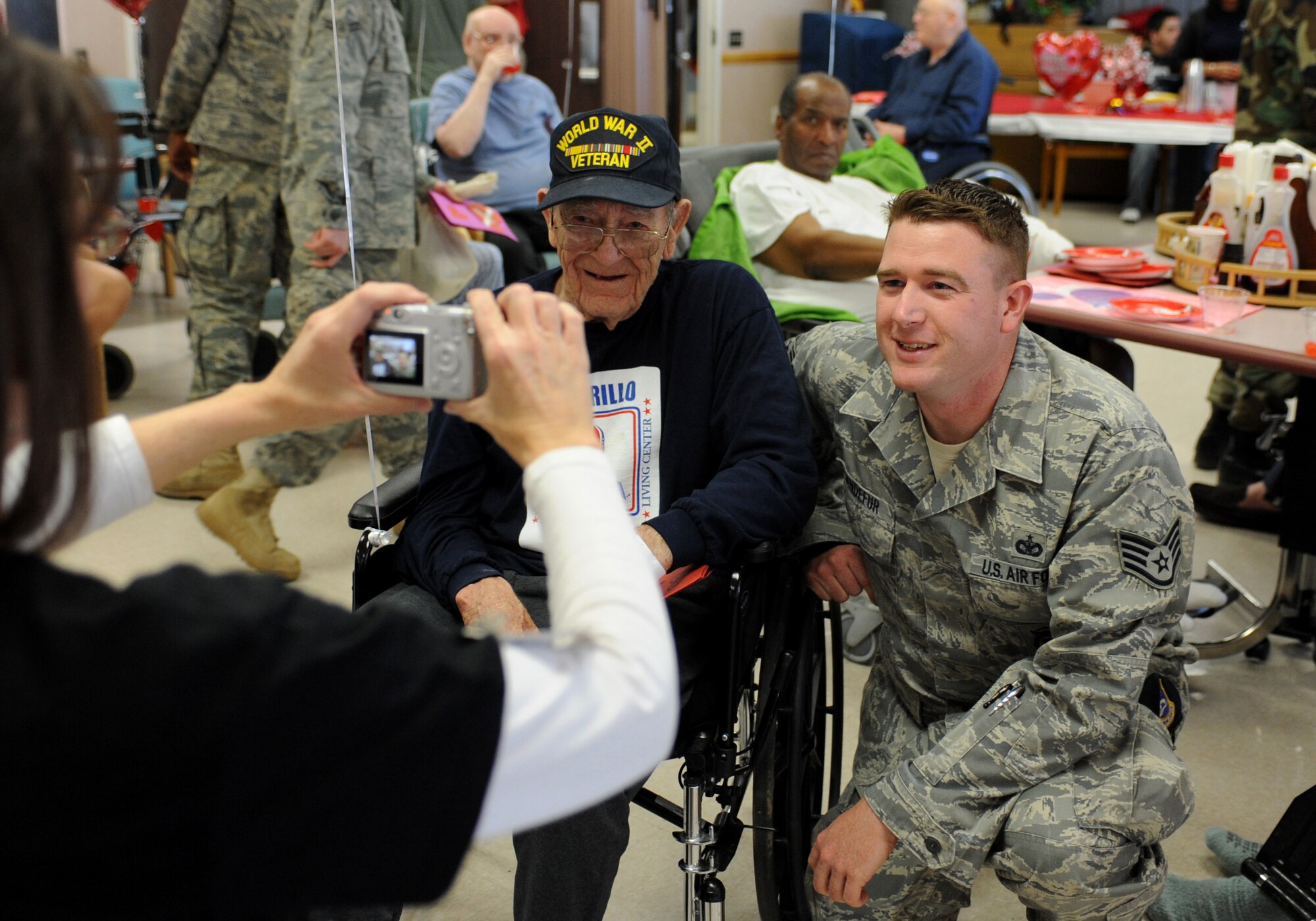 CANNON AIR FORCE BASE, N.M. -- Staff Sgt. Christopher Sanderfur, 27th Special Operations Security Forces Squadron, poses with a veteran for a photo during the Valentines for Veterans visit Feb. 13. Airmen volunteered their time to visit patients of the Thomas E. Creek Department of Veterans Affairs Medical Center in Amarillo, Texas. (U.S. Air Force photo/Airman 1st Class Evelyn Chavez)