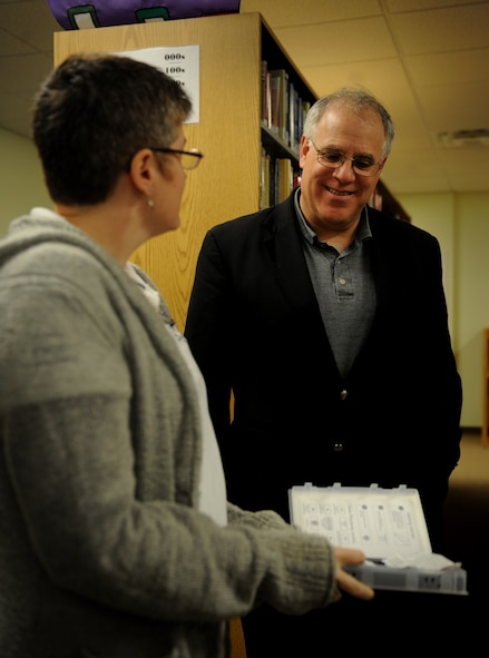 MOODY AIR FORCE BASE, Ga. -- Holly May, 23rd Force Support Squadron Base Library director, shows Dr. Patrick Schloss, Valdosta State University president, an audio book, during his visit here Feb. 20. Dr. Schloss also received a tour of the new Education Office. (U.S. Air Force photo by Senior Airman Gina Chiaverotti)