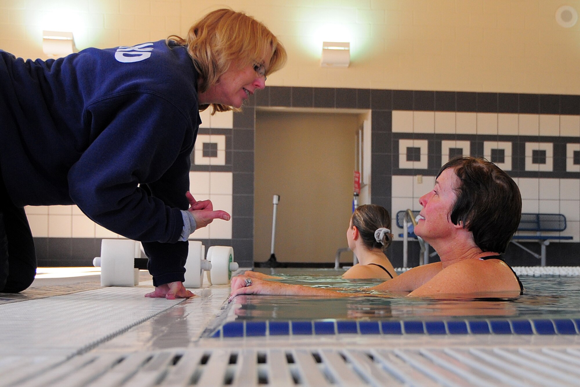 Kathe Peel, 49th Force Support Squadron Fitness and Sports center aquatics director, speaks with Mrs. Barara Sawer of the Base Education Center while teaching a water aerobics class during the Holloman Air Force Base, N.M., Fitness and Sports Center Open House Feb. 20. (U.S. Air Force Photo/Tech. Sgt. Chris Flahive)