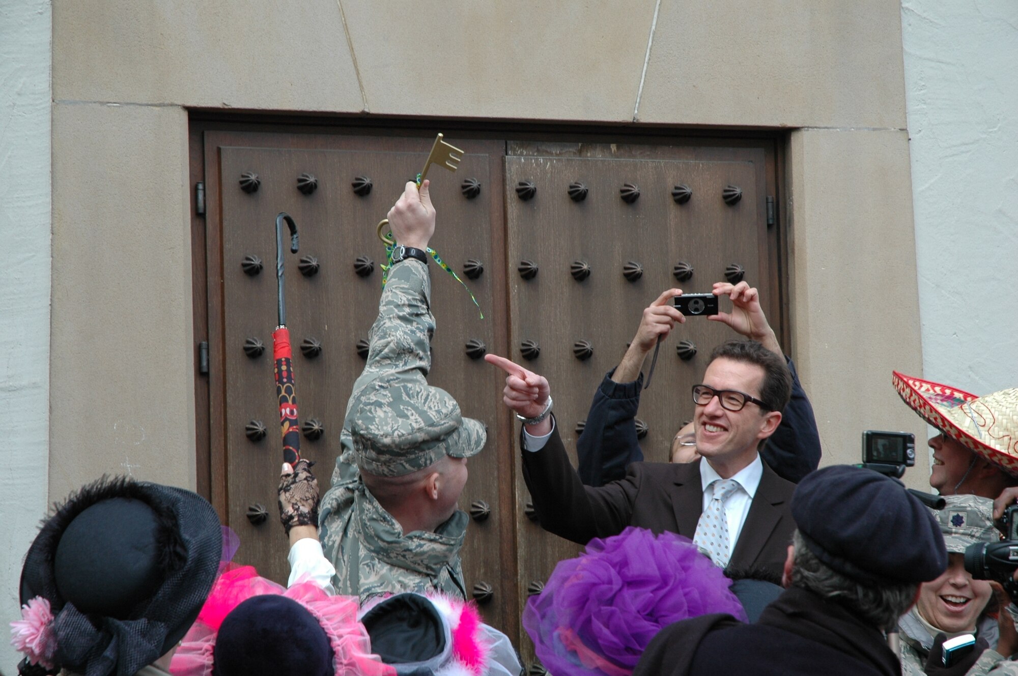 BITBURG, Germany -- Dr. Joachim Streit, mayor of Bitburg, points at the symbolic key that a base member holds up during this year’s Storming of the Rathaus fashing event in Bitburg, Feb. 19, 2009. Once the ladies get the key, they are in charge for the day. A group of base members from the 52nd Medical Group helped the mayor defend the city from the ladies on Fat Thursday. (U.S. Air Force photo by Iris Reiff)