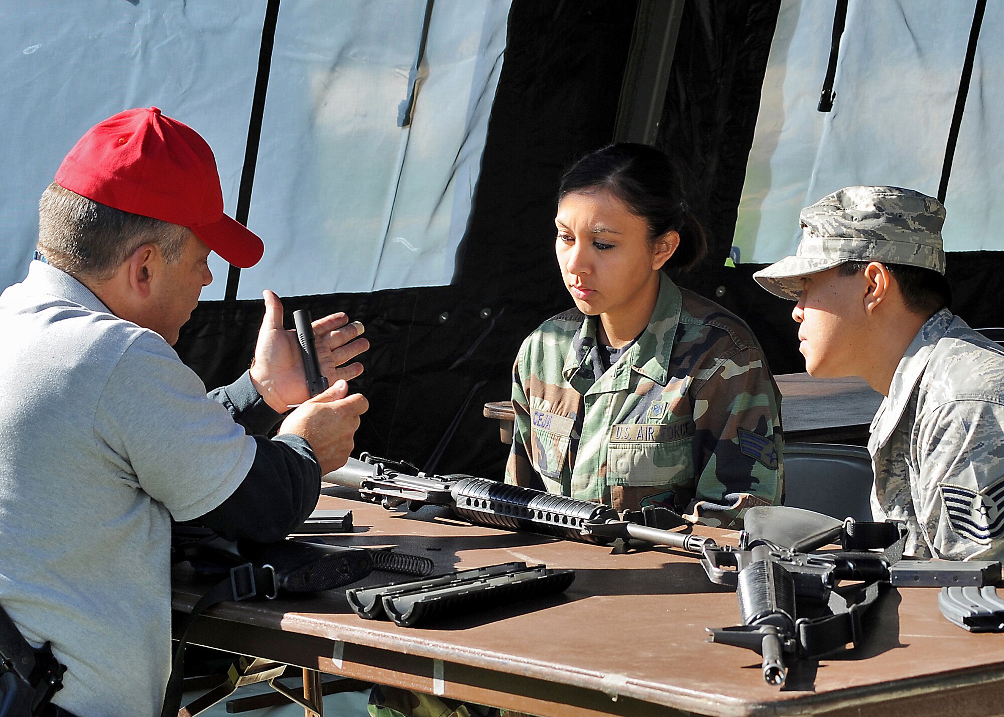 Officer Mark Tuttle (left) of the Security Forces Squadron shows SRA Tania Ceja and Tech Sgt. Alvin Bartolome how to reassemble an M16 during a bi-monthly ATSO (Ability To Survive and Operate) Rodeo, Feb. 12. Los Angeles Air Force Base conducted the exercise in preparation for an upcoming Operation Readiness Evaluation. Four stations were set up for weapons training, self aid and buddy care training, Post Attack Reconnaissance (PAR), and chemical/biological training, (Photo by Joe Juarez) (RELEASED)