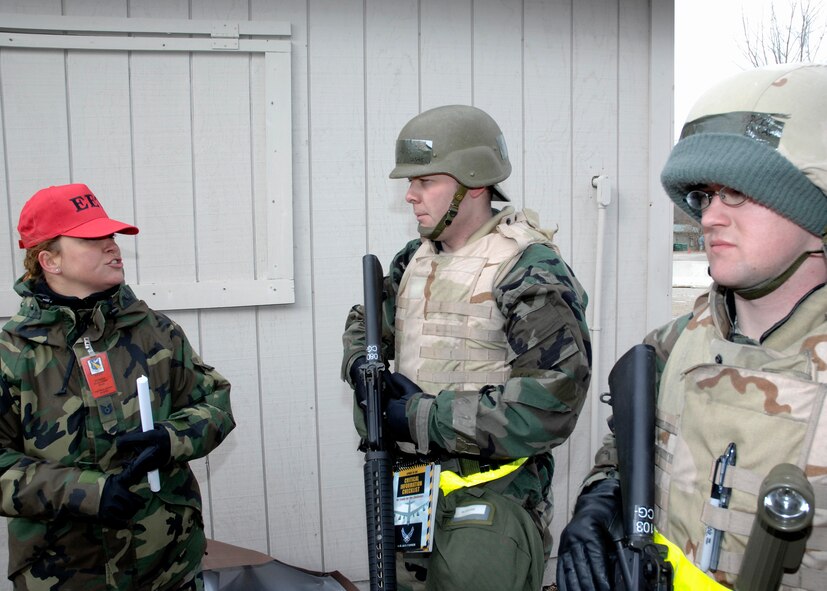 Technical Sgt. Diane Strohm, a member of the exercise evaluation team, instructs two Airmen during a readiness exercise at the Warfighter Training Center at Wright-Patterson Air Force Base.  The exercise, held Feb. 17-20, simulated the deployment of 150 Airmen to Manas Air Force Base, Kyrgyzstan to test the Airmen’s ability to react to a hostile environment in a U.S. Central Command area of responsibility.