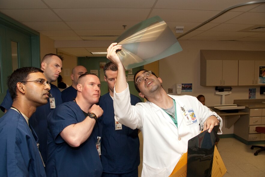 MAJ Emil Fernando, SSGT Brock McNabb, MAJ James Torsney, and DR. Mario Bernal, resident at Centro Medico Hospital, view and x-ray of a gun shot wound at the Centro Medico hospital, in San Juan Puerto Rico. 

Official Air Force Photo by: TSGT. Oscar M. Sanchez
