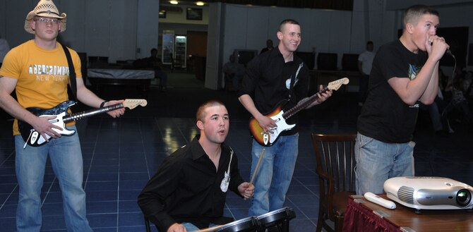 Isaac Born, vocals, Cory Bruns, bass guitar, Chris Adams, drums, and Austin Babcock-Kochera, guitar, compete during "Rockband Jam” tournament at Incirlik’s community center, Feb.20. United States Air Forces in Europe's program "Project Cheer" sponsored the event by donating $300 for the grand prize. (U.S Air Force photo by Senior Airman Erica Stewart)