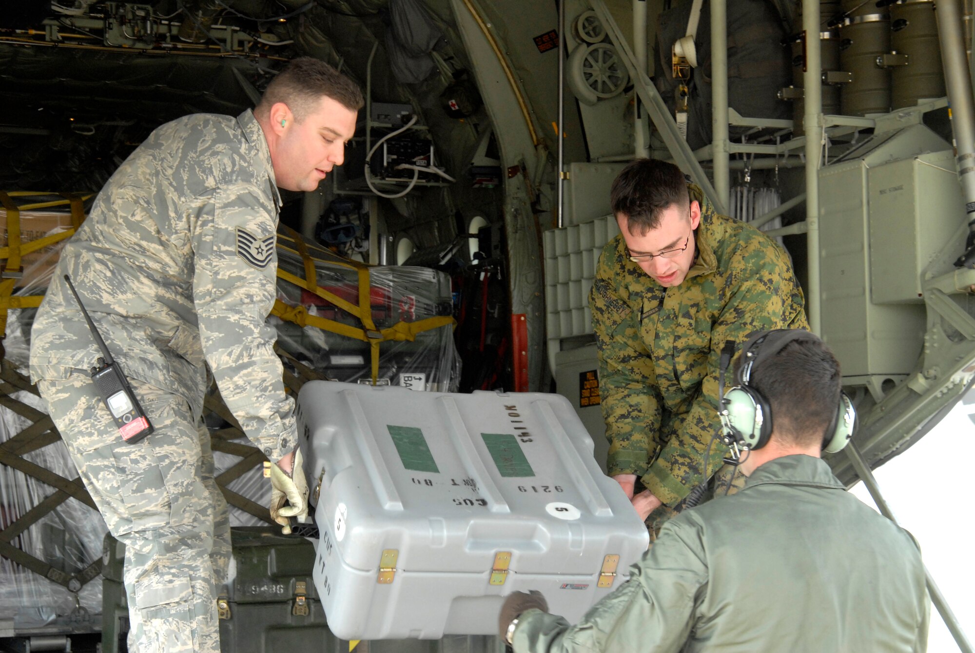Technical Sgt. Anthony Luddon, 8th Logistics Readiness Squadron, and Marine Lance Cpl. Brendon Shaugnessy, Combat Logistics Regiment 37, offload cargo from a Marine Corps KC-130J Super Hercules from Marine Air Station Futenma, Okinawa, Japan, at Kunsan Air Base, Republic of Korea, Feb 23, 2009 . The Marines, here in support of the upcoming exercise Key Resolve, are giving the Airmen at Kunsan a chance to practice accepting follow-on forces, a key component in the Wolfpack mission. (U.S. Air Force Photo by SSgt Jason Colbert)