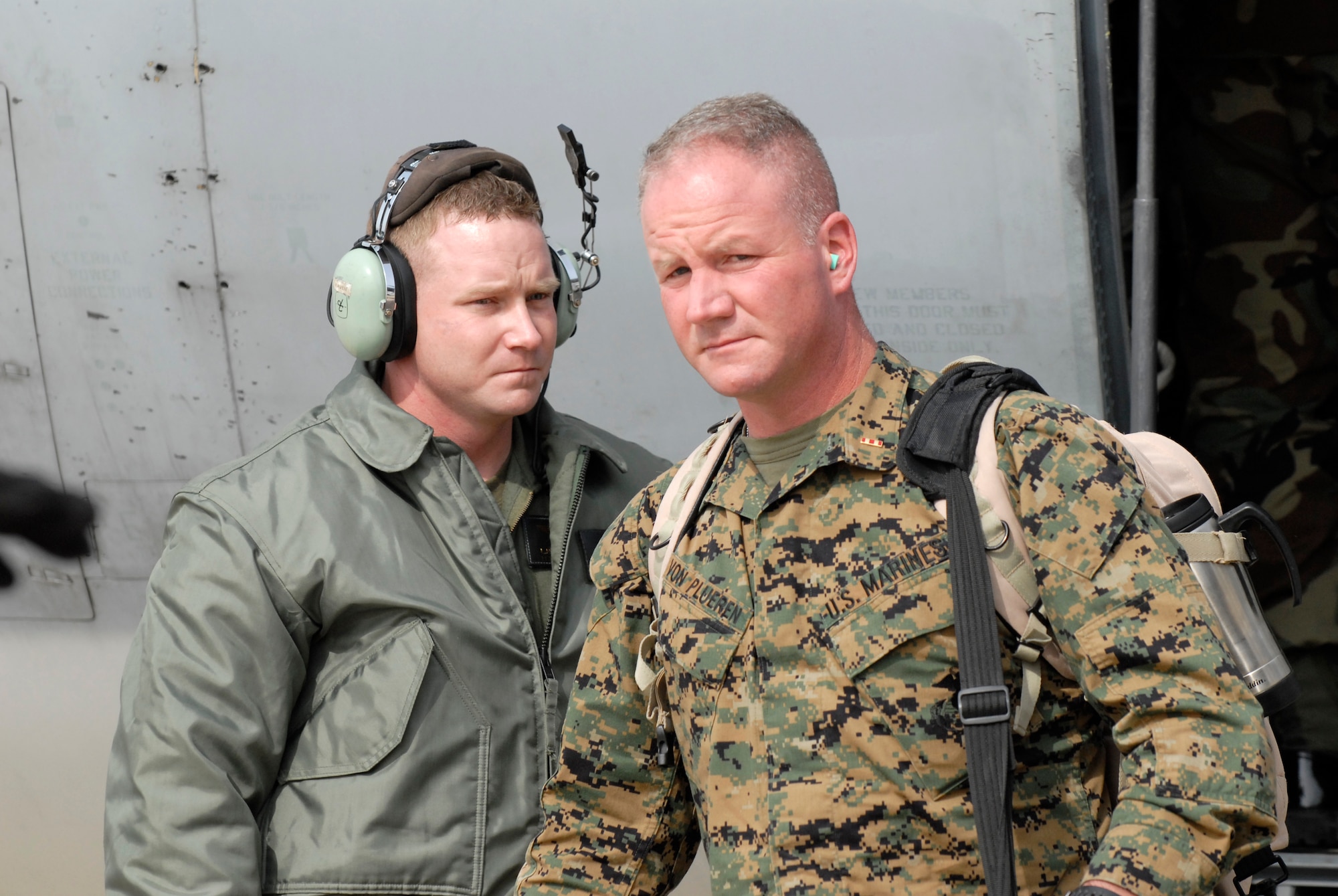 Marine Chief Warrant Officer 2 James Von Plueren, Telephone Systems Officer with the Marine Wing Communcations Squadron 18 from Marine Air Station Futenma, Okinawa, Japan, offloads from a KC-130J Super Hercules, Feb 23, 2009 at Kunsan Air Base, Republic of Korea. The Marines are here in support of the upcoming exercise Key Resolve. (U.S. Air Force Photo by SSgt Jason Colbert)