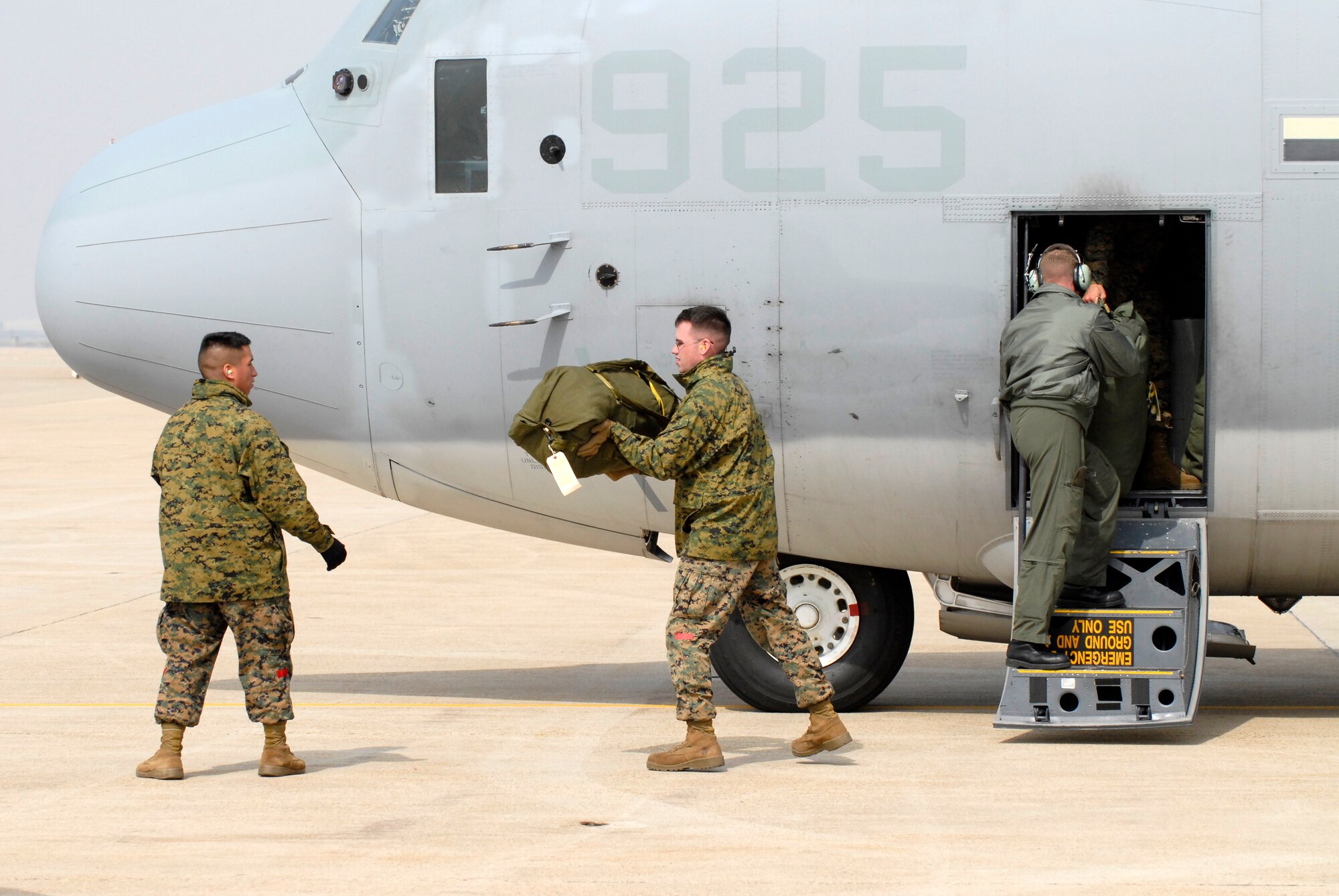Marines from the 1st Marine Aircraft Wing, Marine Air Station Futenma, Okinawa, Japan, offload luggage from a KC-130J Super Hercules, Feb 23, 2009 at Kunsan Air Base, Republic of Korea. The Marines are here in support of the upcoming exercise Key Resolve. (U.S. Air Force Photo by SSgt Jason Colbert)