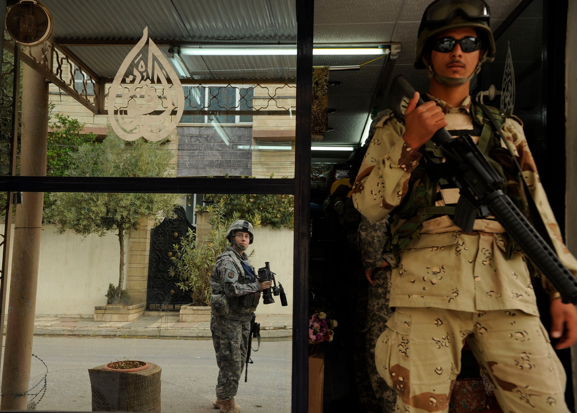 Tech. Sgt. Adrienne Brammer, Combat Videographer from 1st Combat Camera Squadron from Charleston Air Force Base, S.C., documents a joint patrol between U.S. Army soldiers from 3rd Squadron, 3rd Armored Cavalry Regiment and Iraqi army soldiers in Al Muhandiseen, Iraq, Oct. 30. (U.S. Air Force Staff Sgt. JoAnn S. Makinano)