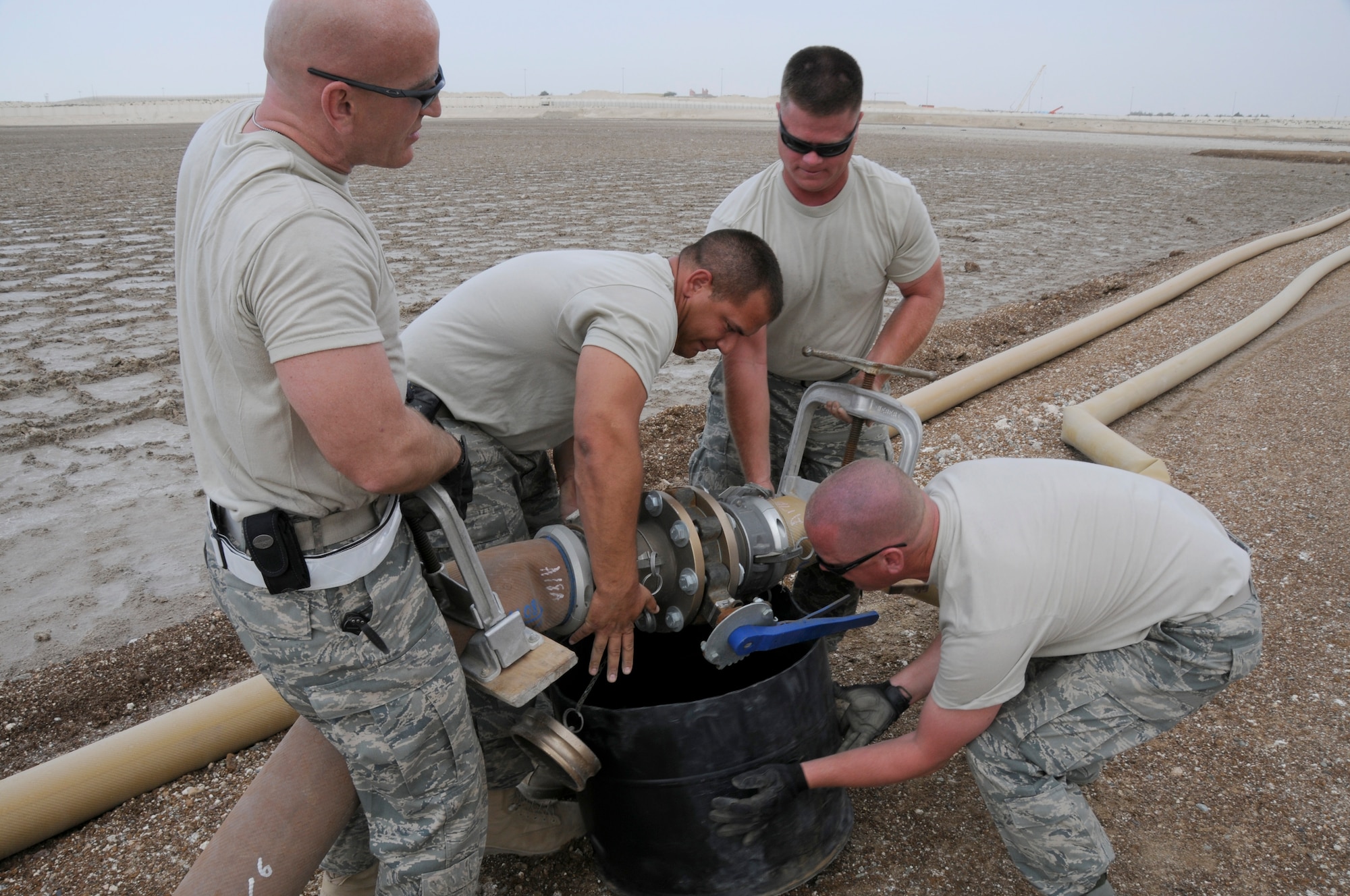 SOUTHWEST ASIA - Chief Master Sgt. George Treleor, Tech Sgt. David Butts, Staff Sgt. Joshua Schubert and Tech. Sgt. Ron Evenson, 380th Expeditionary Logistics Readiness Squadron, fuels flight, position a fuel line to be disconnected and drained of residual, Feb 7. The fuels flight upgraded the fuel line named "python", changing out 5000ft, upgrading the old worn line ensuring a steady flow of fuel to the base. The fuels flight will replace an additional 3000ft within the next few weeks. Chief Treleor, Sergeant Shubert and Sergeant Evenson are deployed from Eglin AFB, Fla. and Sergeant Butts is deployed from Nellis AFB, Nev. Chief Treleor hails from Philadelphia, Pa., Sergeant Butts is from Las Vegas, Nev., Sergeant Shubert is from Hatboro, Pa. and Sergeant Evenson is from Lena, Ill. (U.S. Air Force photo by Senior Airman Brian J. Ellis) (Released)