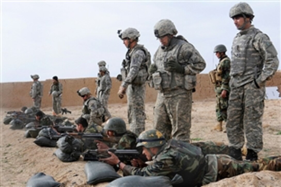 U.S. Army soldiers look on as Afghan National Army soldiers zero their weapons during basic rifle marksmanship training on Bagram Air Field, Afghanistan, Feb. 11, 2009. The soldiers are assigned to the 1st Infantry Division's Company D, 2nd Battalion, 2nd Infantry Regiment, 3rd Brigade Combat Team.