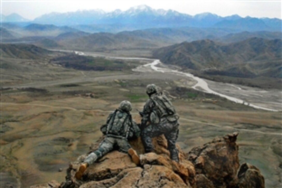 U.S. Army 1st Lt. Jared Tomberlin, left, gets a first-hand view of the land with outgoing commander 1st Lt. Larry Baca on top of a ridge near Forward Operation Base Lane, Zabul province, Afghanistan, Feb. 21, 2009. Tomberlin is assigned to Company B, 1st Battalion, 4th Infantry Regiment and Baca is assigned to Company C, 1st Battalion, 4th Infantry Regiment.