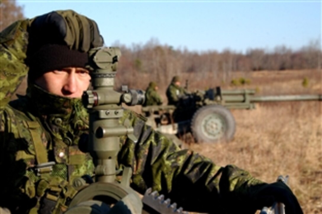 Canadian bombardier Anthony LaViolette bore sites a C3 105 mm Howitzer during Exercise Southbound Trooper IX on Fort Pickett, Va., Feb. 20, 2009. The exercise is an annual multinational event to prepare soldiers for future deployments.