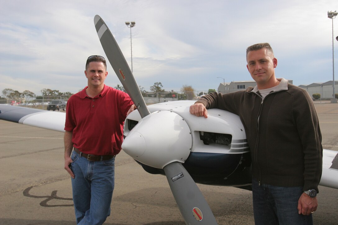Staff Sgt. Greg Davidson (left), substance abuse couseling officer, supply battalion, Combat Logistics Regiment 15, 1st Marine Logistics Group, and Master Sgt. Thomas W. Shalhoub, ordance chief, armory, Headquarters & Support Battalion, School of Infantry West, stand beside a Seminole airplane. Davidson and Shalhoub both fly airplanes recreationally in their freetime and are actively persueing avaition education and careers.